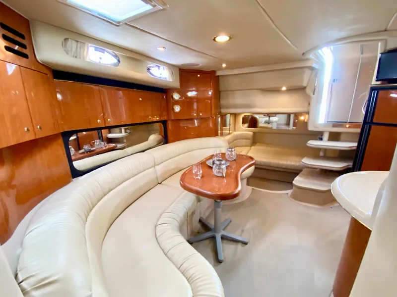 Slide: The Image of Luxurious interior of 2000 Sea Ray 380 Sundancer yacht with plush seating and elegant wood finishes. - 24