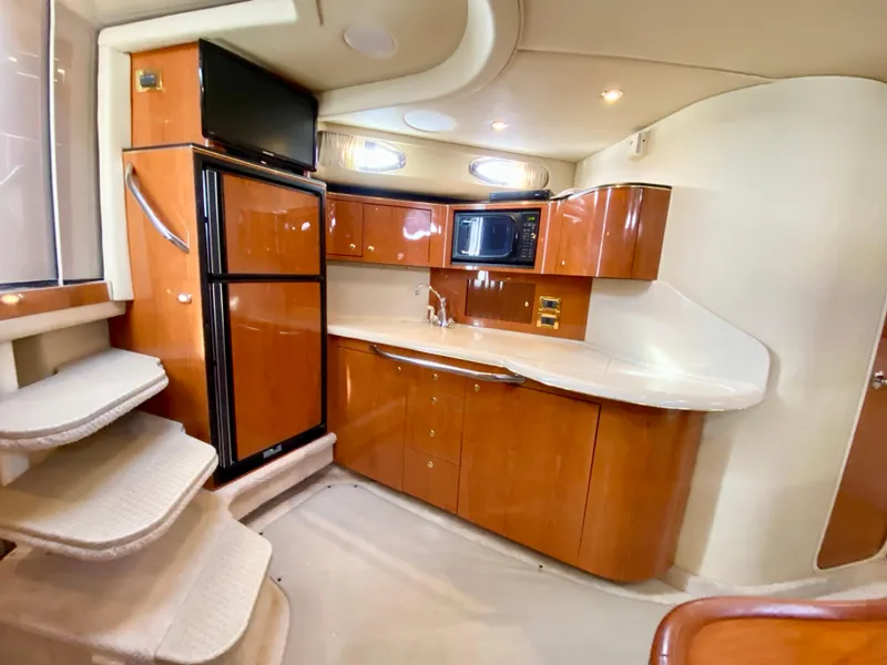 Slide: The Image of Interior of 2000 Sea Ray 380 Sundancer yacht with kitchen and stairs. - 25