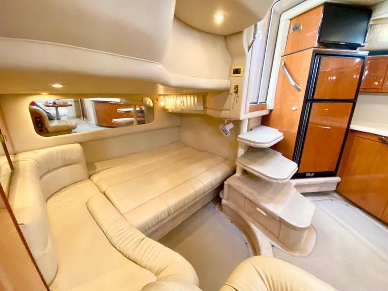 Slide: The Image of Luxurious interior of 2000 Sea Ray 380 Sundancer yacht with beige seating and wood accents. - 26
