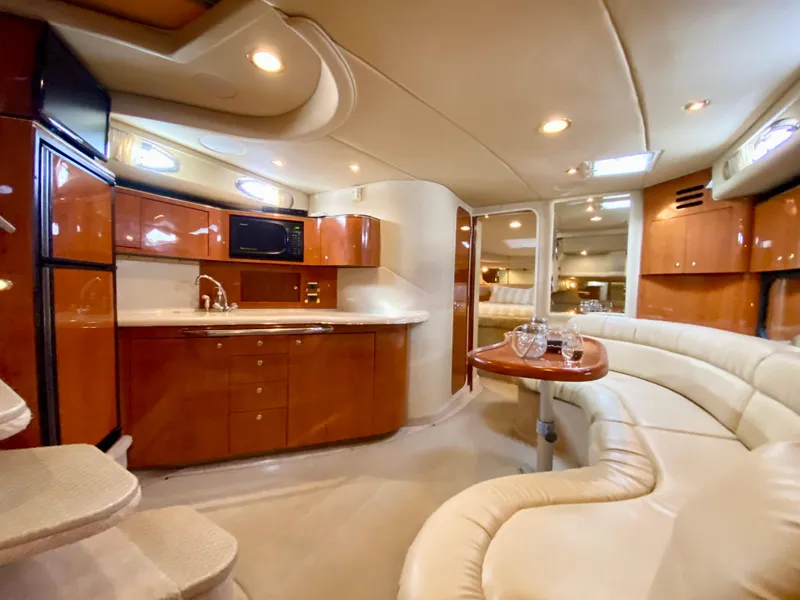 Slide: The Image of Luxurious interior of 2000 Sea Ray 380 Sundancer yacht with kitchen and seating area. - 28