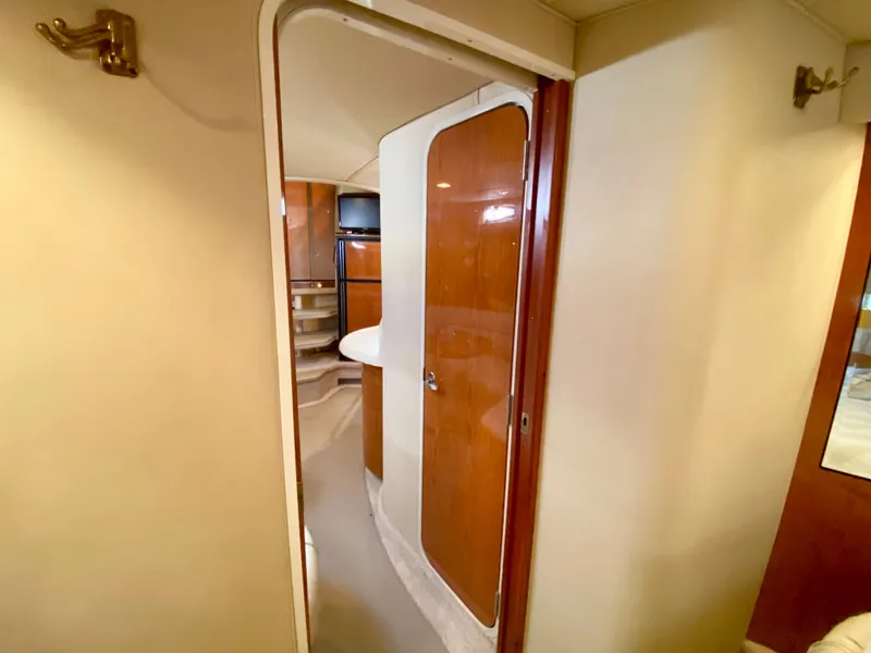 Slide: The Image of Interior view of 2000 Sea Ray 380 Sundancer yacht, featuring wooden cabinetry and modern design. - 34