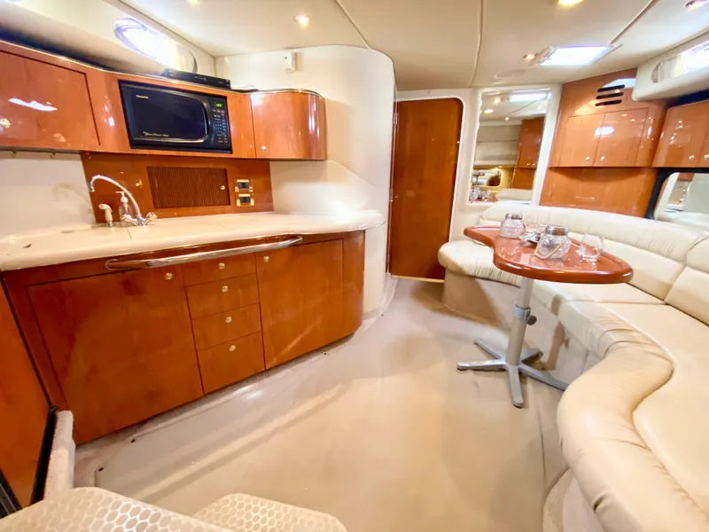 Slide: The Image of Luxurious interior of 2000 Sea Ray 380 Sundancer yacht with kitchen and seating area. - 39