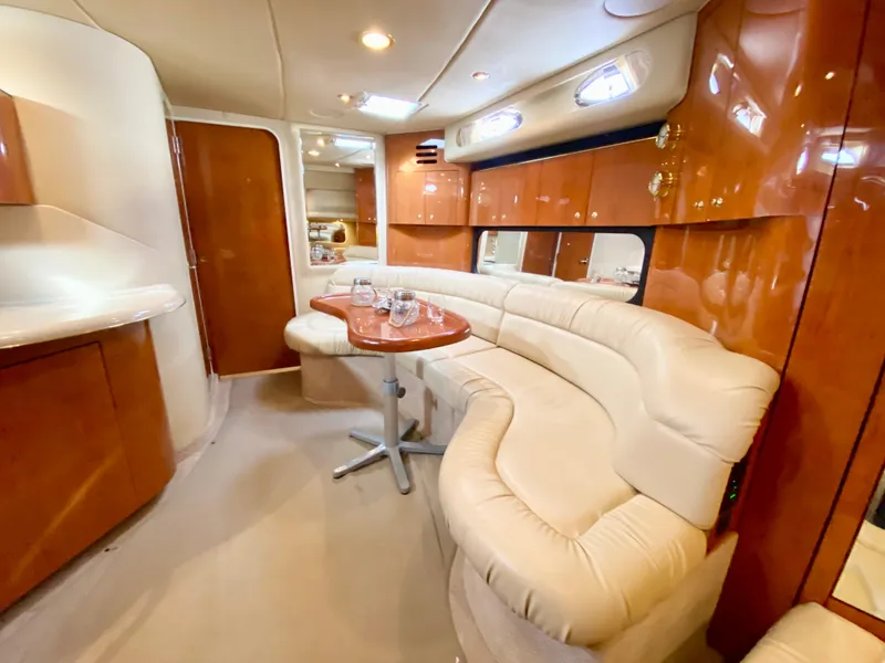 Slide: The Image of Luxurious interior of 2000 Sea Ray 380 Sundancer yacht with plush seating and wooden finishes. - 40