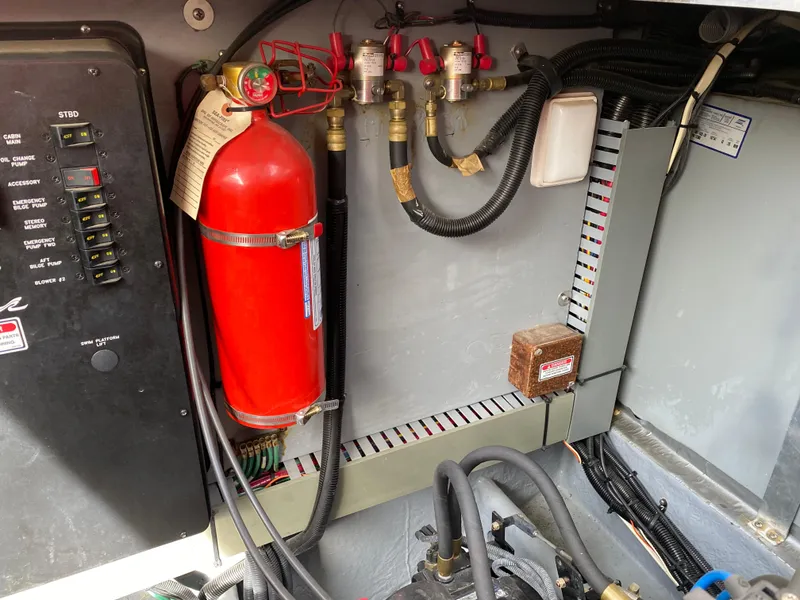 Slide: The Image of Engine compartment of 2000 Sea Ray 380 Sundancer with fire extinguisher and wiring. - 46
