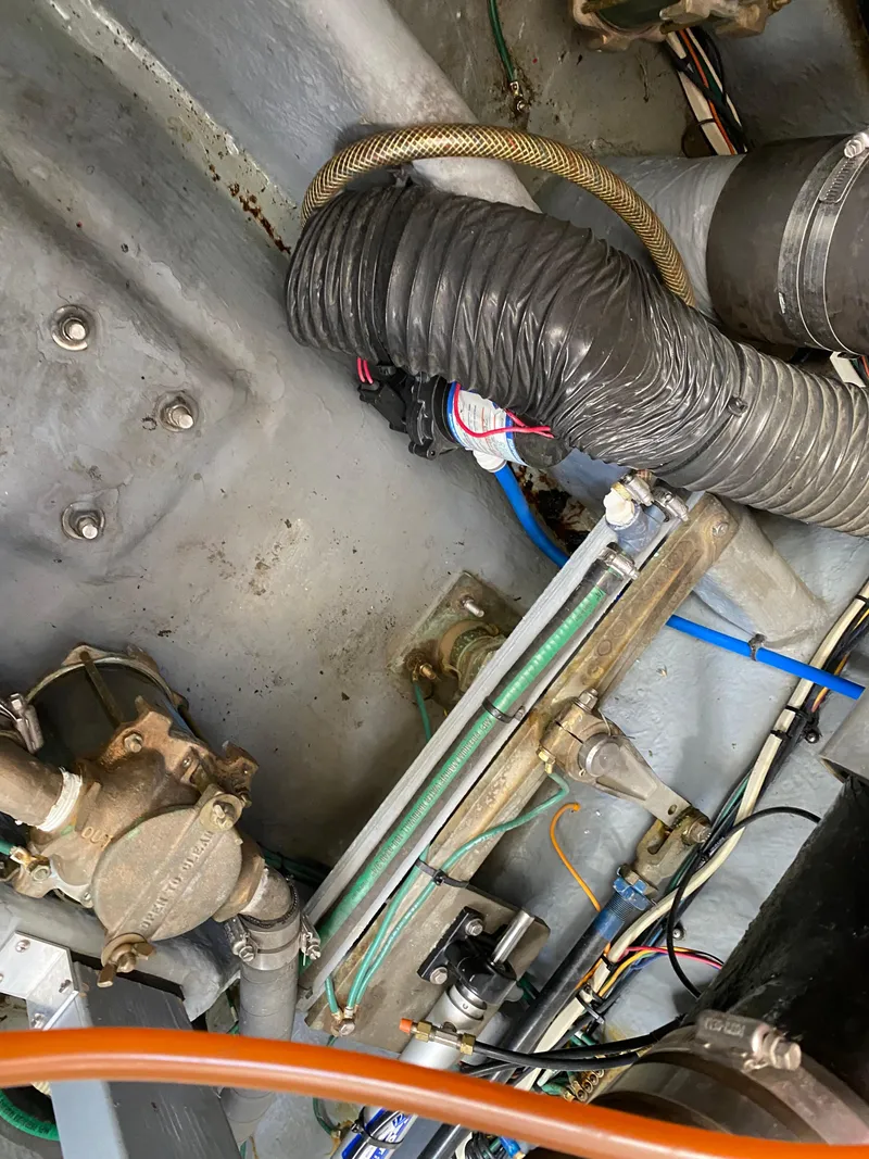 Slide: The Image of Engine compartment of a 2000 Sea Ray 380 Sundancer with visible hoses and wiring. - 48