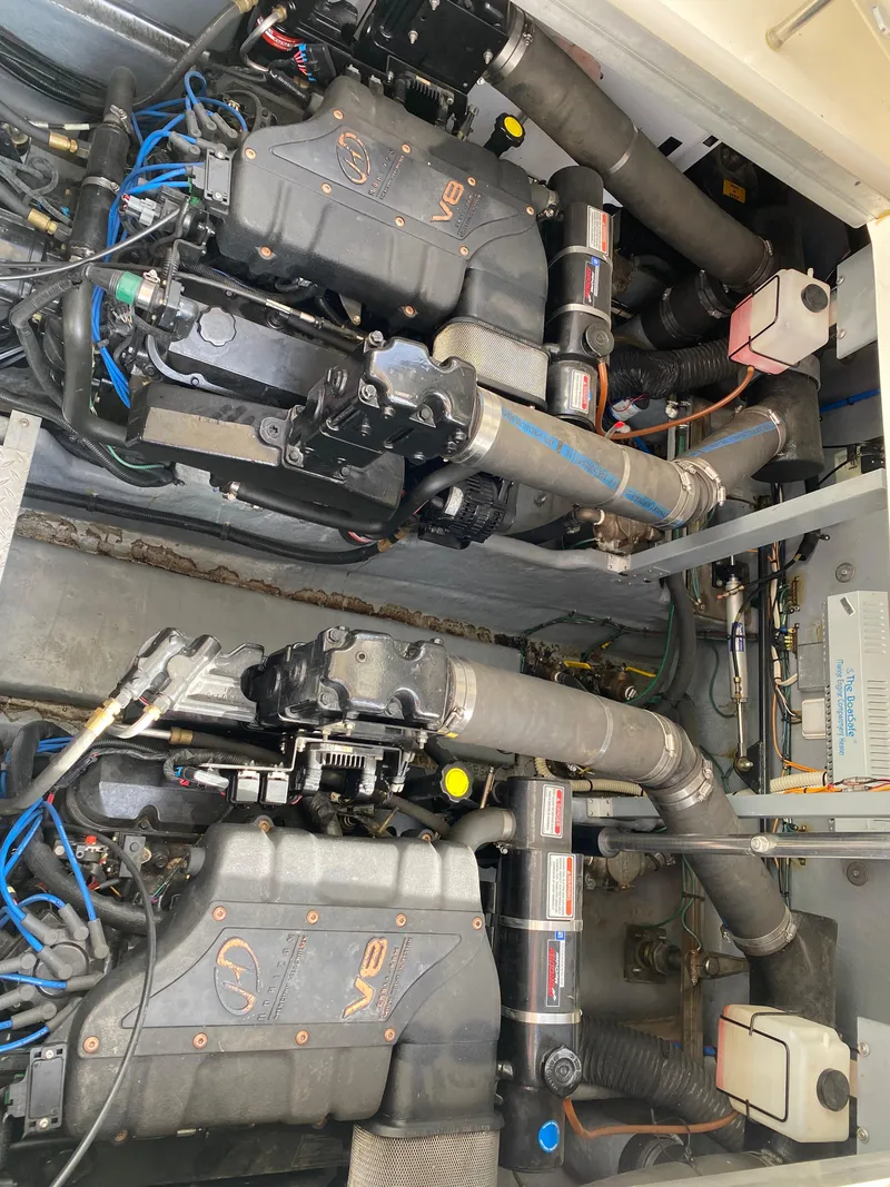 Slide: The Image of Engine compartment of 2000 Sea Ray 380 Sundancer boat, showcasing dual engines and components. - 49