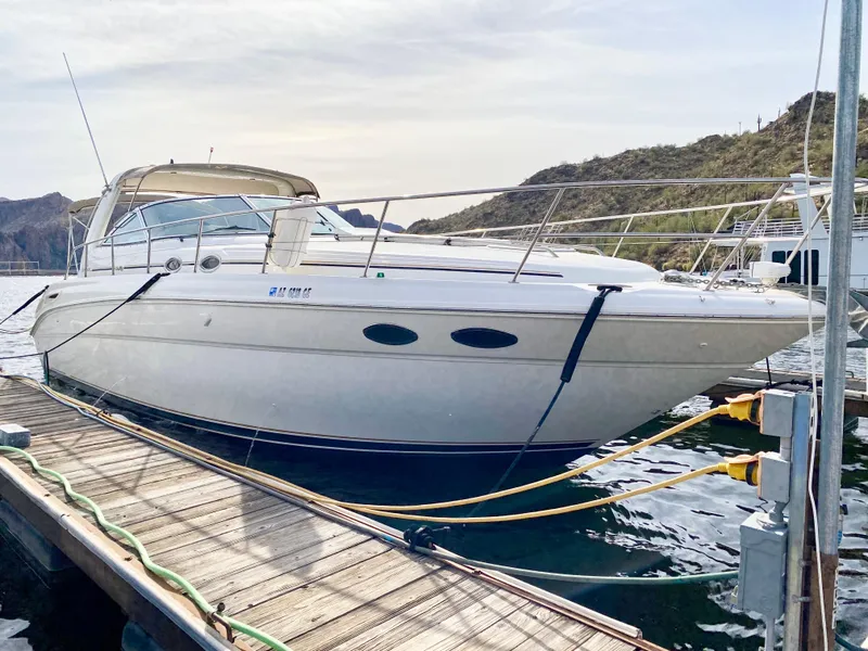 Slide: The Image of 2000 Sea Ray 380 Sundancer docked at marina, scenic background. - 5