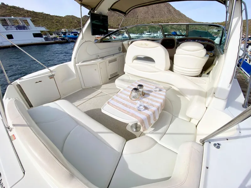 Slide: The Image of Sea Ray 380 Sundancer 2000 yacht interior with seating and table on a sunny day. - 6