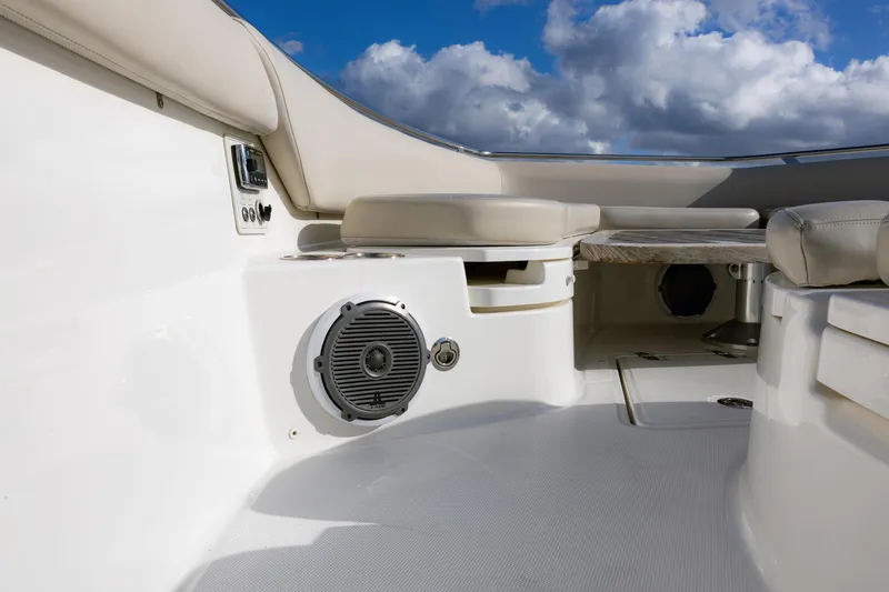 Slide: The Image of 2017 Boston Whaler 420 Outrage interior with seating and speaker, under a cloudy sky. - 11