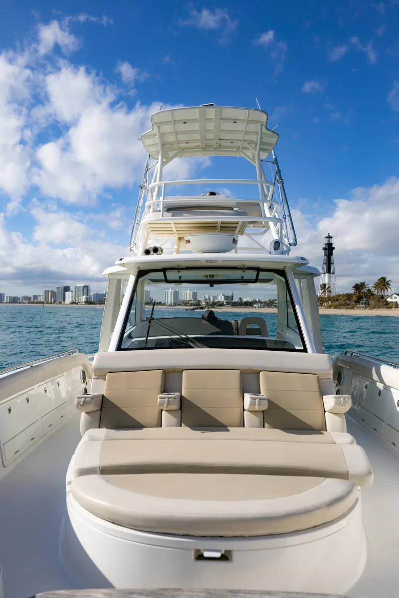 Slide: The Image of 2017 Boston Whaler 420 Outrage boat on open water with city skyline. - 12