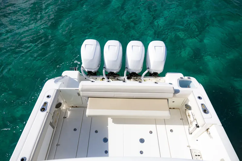 Slide: The Image of Boston Whaler 420 Outrage 2017 boat with four engines on turquoise water. - 2