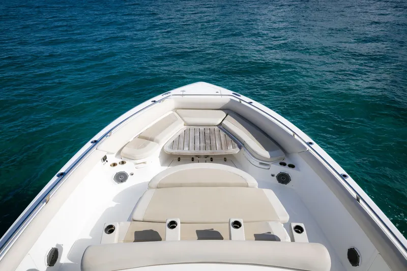 Slide: The Image of 2017 Boston Whaler 420 Outrage boat bow on clear blue water. - 3