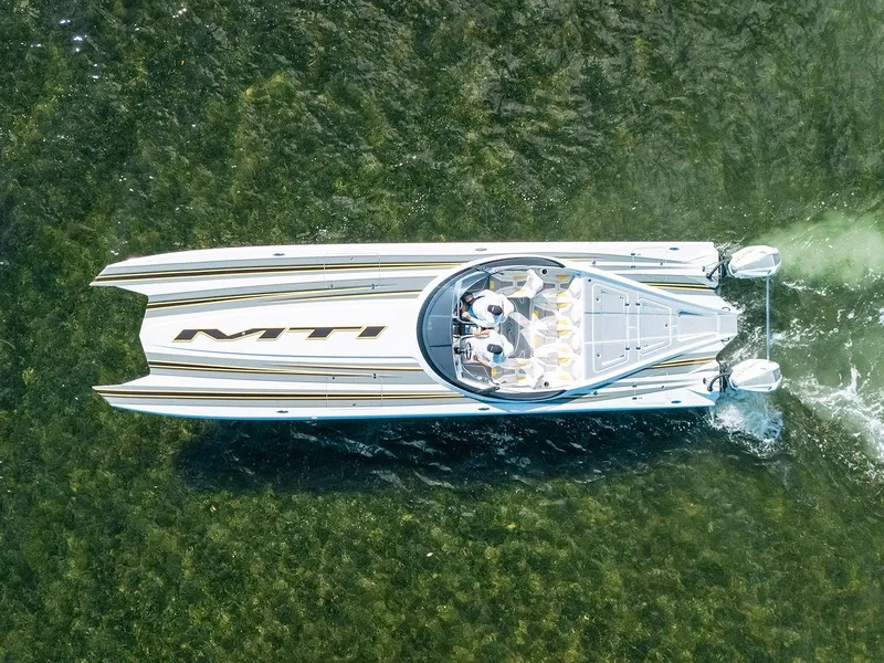 Slide: The Image of Aerial view of 2022 MTI 390X speedboat cruising on clear water. - 2