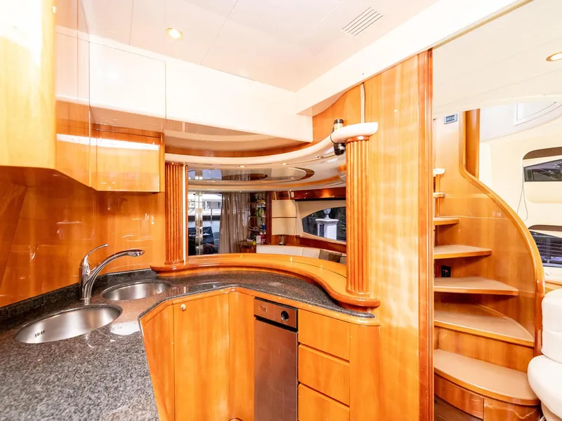 Slide: The Image of Luxurious kitchen interior of 2000 Azimut 70 Sea-Jet yacht with wooden cabinetry and spiral staircase. - 20