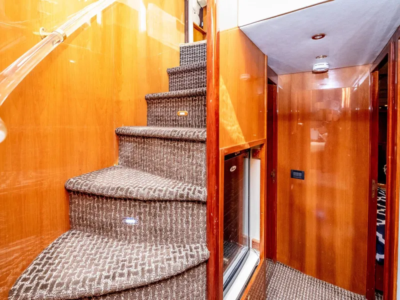 Slide: The Image of Interior of 2000 Azimut 70 Sea-Jet yacht with carpeted stairs and wooden paneling. - 46