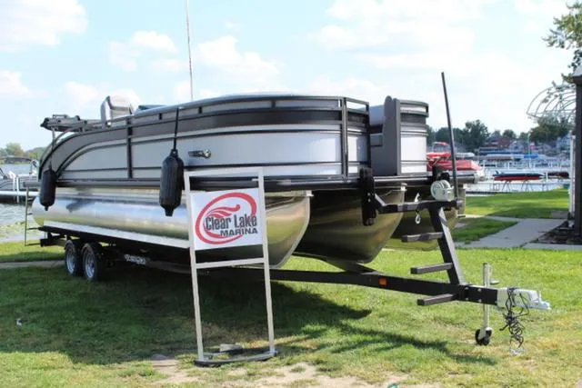 Slide: The Image of 2024 Harris Solstice 250 SL pontoon boat on trailer at Clear Lake Marina. - 1