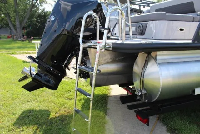 Slide: The Image of 2024 Harris Solstice 250 SL pontoon boat with ladder and outboard motor. - 10