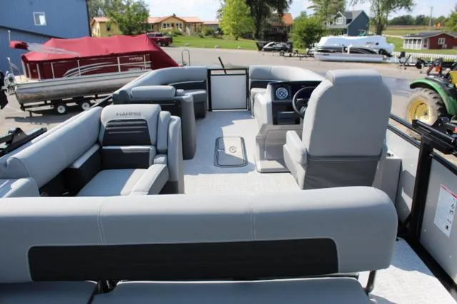 Slide: The Image of 2024 Harris Solstice 250 SL pontoon boat with spacious seating and modern design. - 17