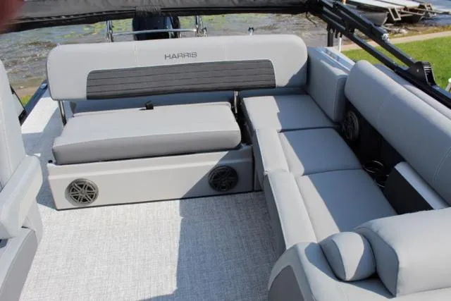 Slide: The Image of 2024 Harris Solstice 250 SL boat interior with gray seating and speakers. - 18