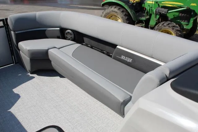 Slide: The Image of 2024 Harris Solstice 250 SL boat interior with gray seating and speaker system. - 23