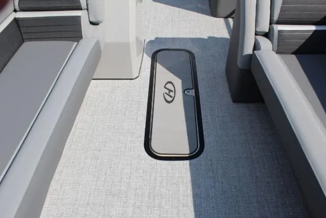 Slide: The Image of 2024 Harris Solstice 250 SL boat interior with sleek seating and storage compartment. - 25
