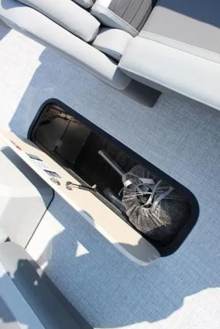 Slide: The Image of 2024 Harris Solstice 250 SL boat storage compartment with gear inside. - 26