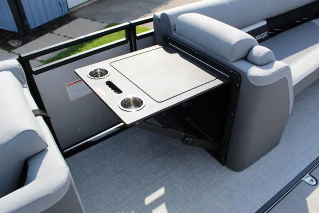 Slide: The Image of 2024 Harris Solstice 250 SL boat interior with fold-out table and cup holders. - 28