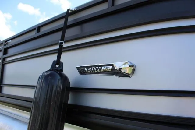 Slide: The Image of 2024 Harris Solstice 250 SL boat side view with logo and fender. - 7