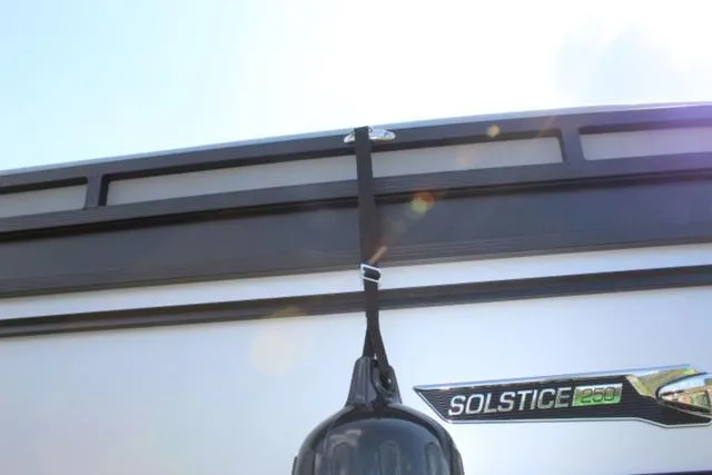 Slide: The Image of 2024 Harris Solstice 250 SL boat with logo and hanging fender. - 8
