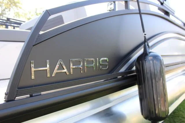 Slide: The Image of 2024 Harris Solstice 250 SL pontoon boat with sleek design and branding. - 9