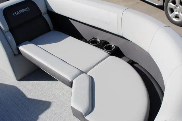 Slide: The Image of 2024 Harris Cruiser 230 CS boat interior with gray seating and cup holders. - 10