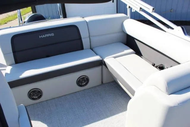 Slide: The Image of 2024 Harris Cruiser 230 CS boat interior with gray seating and built-in speakers. - 12