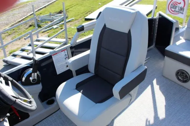 Slide: The Image of 2024 Harris Cruiser 230 CS boat interior with captain's chair and steering console. - 13