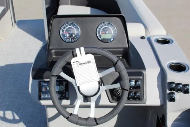 Slide: The Image of 2024 Harris Cruiser 230 CS dashboard with steering wheel and gauges. - 14