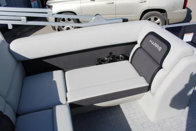 Slide: The Image of 2024 Harris Cruiser 230 CS interior seating with cup holders, featuring sleek gray and black design. - 19