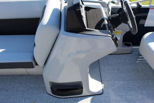 Slide: The Image of 2024 Harris Cruiser 230 CS boat interior with steering console and seating. - 21