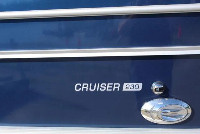 Slide: The Image of 2024 Harris Cruiser 230 CS boat exterior with logo and chrome detail. - 3