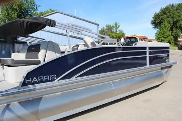 Slide: The Image of 2024 Harris Cruiser 230 CS pontoon boat, sleek design, docked outdoors. - 4