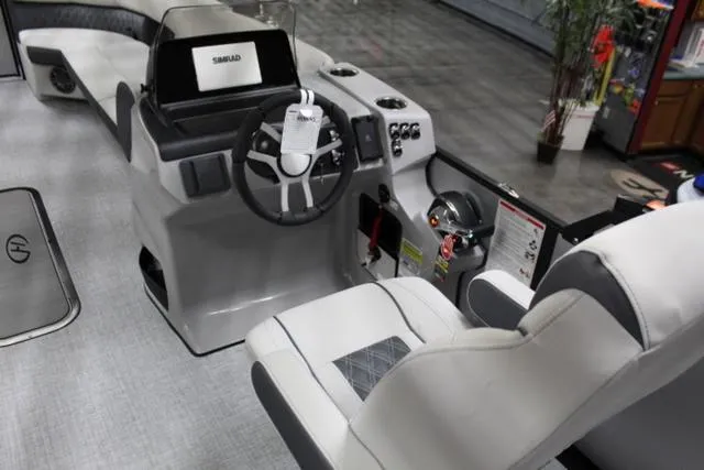 Slide: The Image of 2024 Harris Sunliner 250 SLDH boat interior with modern helm and seating. - 12