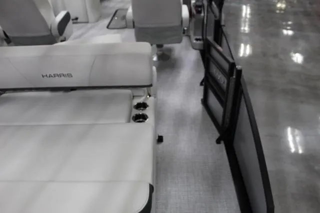 Slide: The Image of 2024 Harris Sunliner 250 SLDH boat interior with plush seating and cup holders. - 14