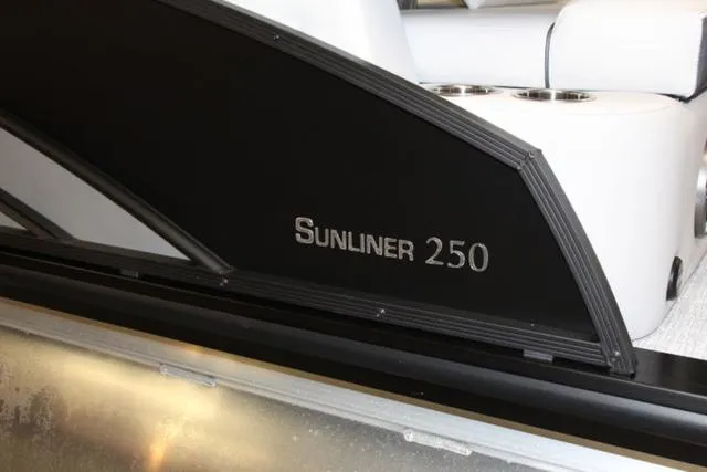 Slide: The Image of 2024 Harris Sunliner 250 SLDH boat interior with sleek black paneling. - 15
