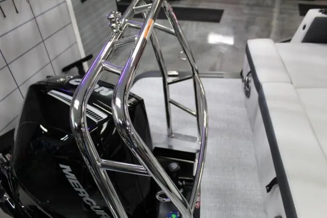 Slide: The Image of 2024 Harris Sunliner 250 SLDH boat with Mercury engine and sleek seating. - 17