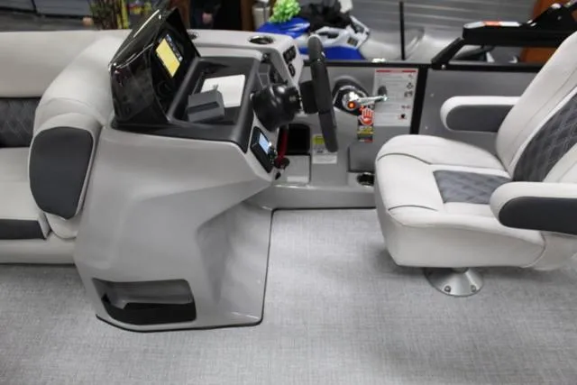 Slide: The Image of 2024 Harris Sunliner 250 SLDH boat interior with modern helm and seating. - 23