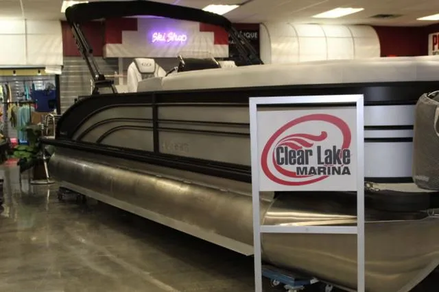 Slide: The Image of 2024 Harris Sunliner 250 SLDH pontoon boat displayed at Clear Lake Marina showroom. - 3