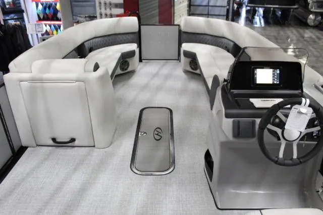 Slide: The Image of 2024 Harris Sunliner 250 SLDH pontoon boat interior with modern seating and steering console. - 7