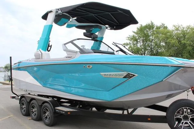 Slide: The Image of 2022 Nautique G23 Paragon boat with vibrant blue exterior on a trailer. - 10