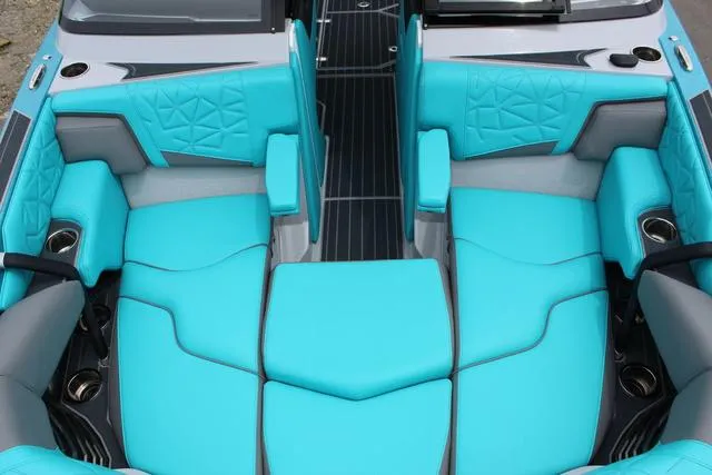 Slide: The Image of 2022 Nautique G23 Paragon interior with turquoise seating and modern design. - 12