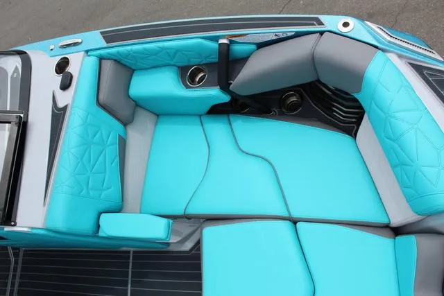 Slide: The Image of 2022 Nautique G23 Paragon boat interior with turquoise and gray seating. - 13