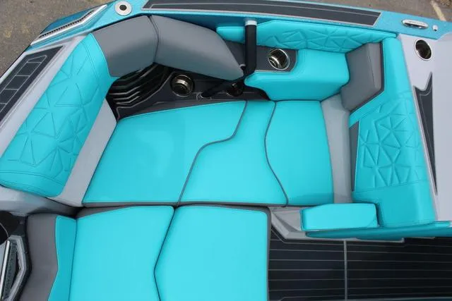 Slide: The Image of 2022 Nautique G23 Paragon boat interior with turquoise and gray seating. - 14