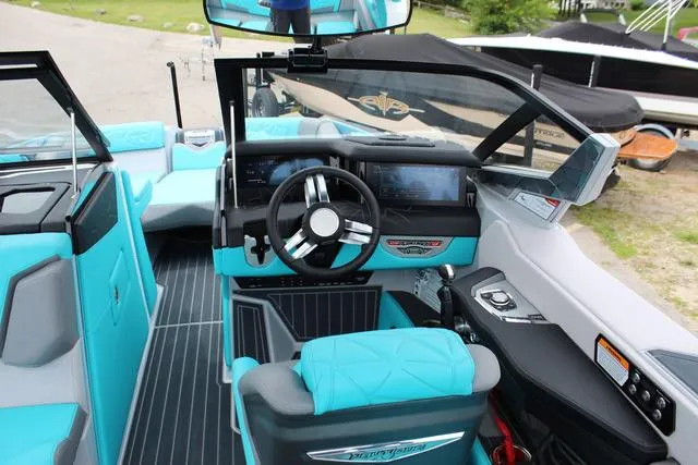 Slide: The Image of 2022 Nautique G23 Paragon boat interior with turquoise seating and modern dashboard. - 15